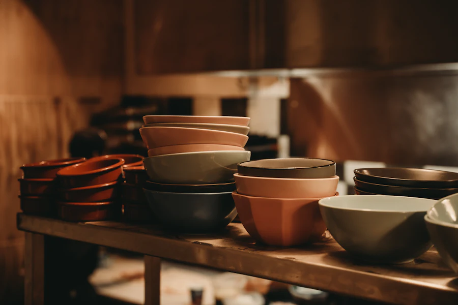 A shelf of bowls in tenmoku, celadon and shino